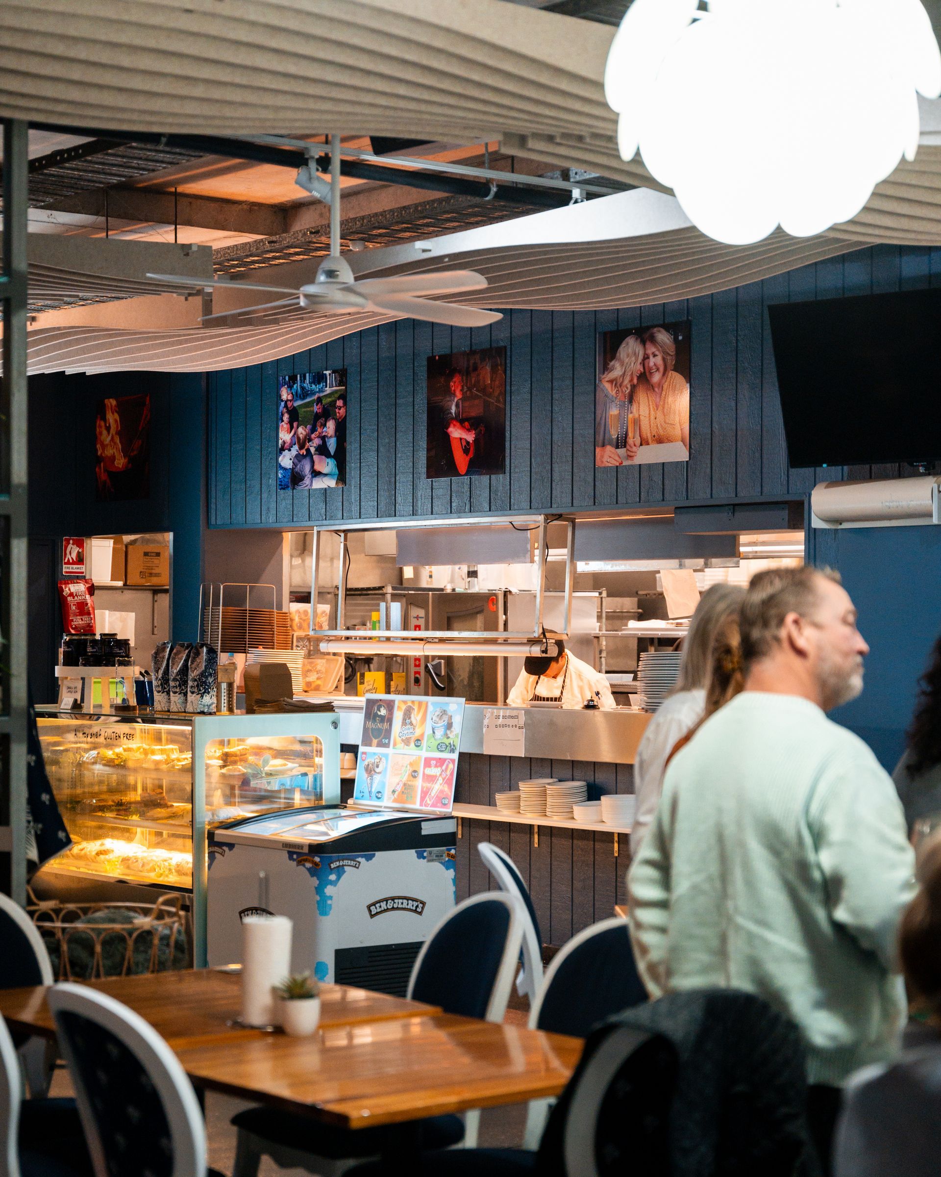 A Group of People Are Sitting at Tables in A Restaurant — Chop 'n Chill in Port Macquarie, NSW