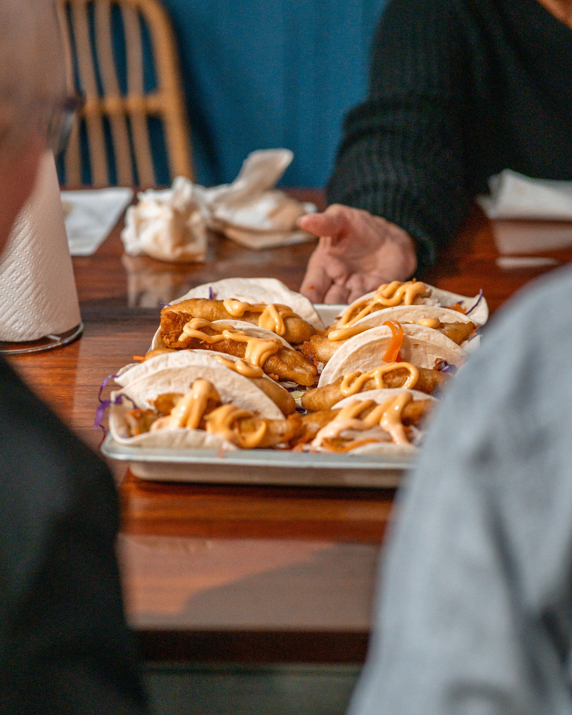 A Person Is Sitting at A Table with A Tray of Food on It — Chop 'n Chill in Port Macquarie, NSW