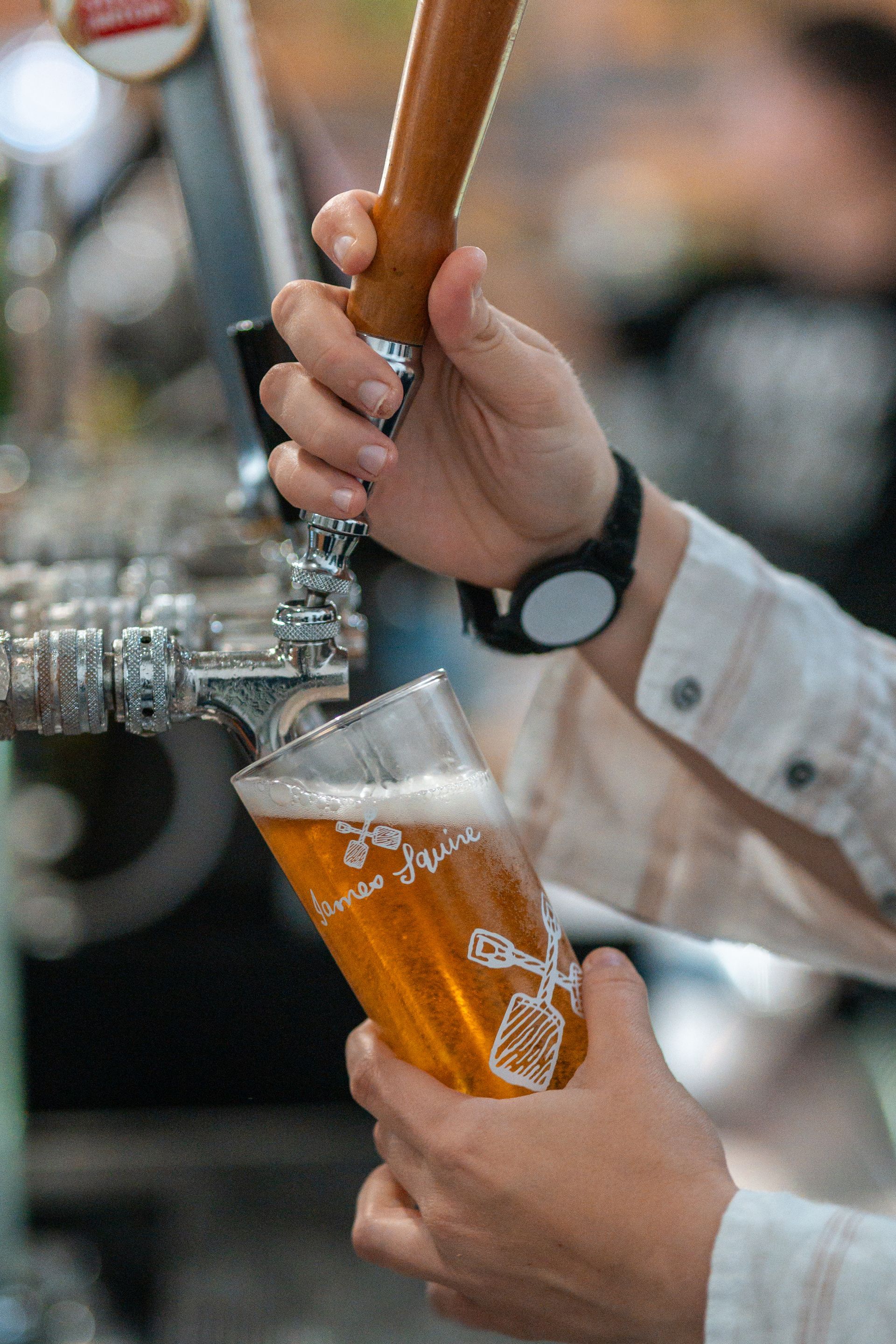 A Person Is Pouring Beer Into a Glass from A Tap — Chop 'n Chill in Port Macquarie, NSW