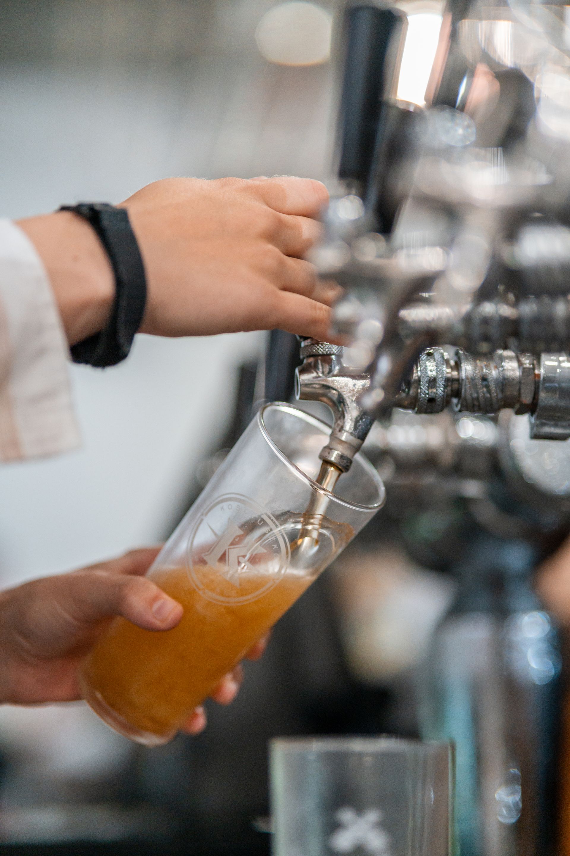 A Person Is Pouring Beer Into a Glass from A Tap — Chop 'n Chill in Port Macquarie, NSW