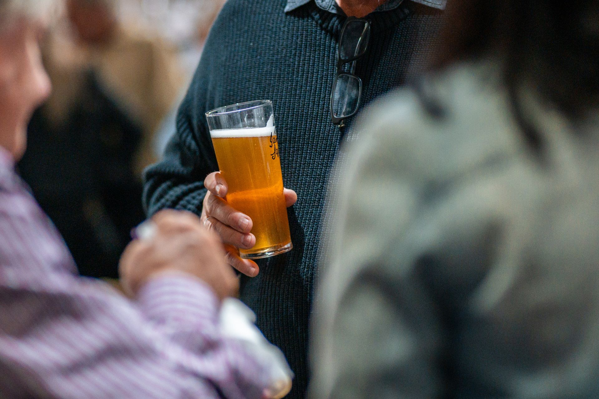 A Man Is Holding a Glass of Beer in His Hand — Chop 'n Chill in Port Macquarie, NSW