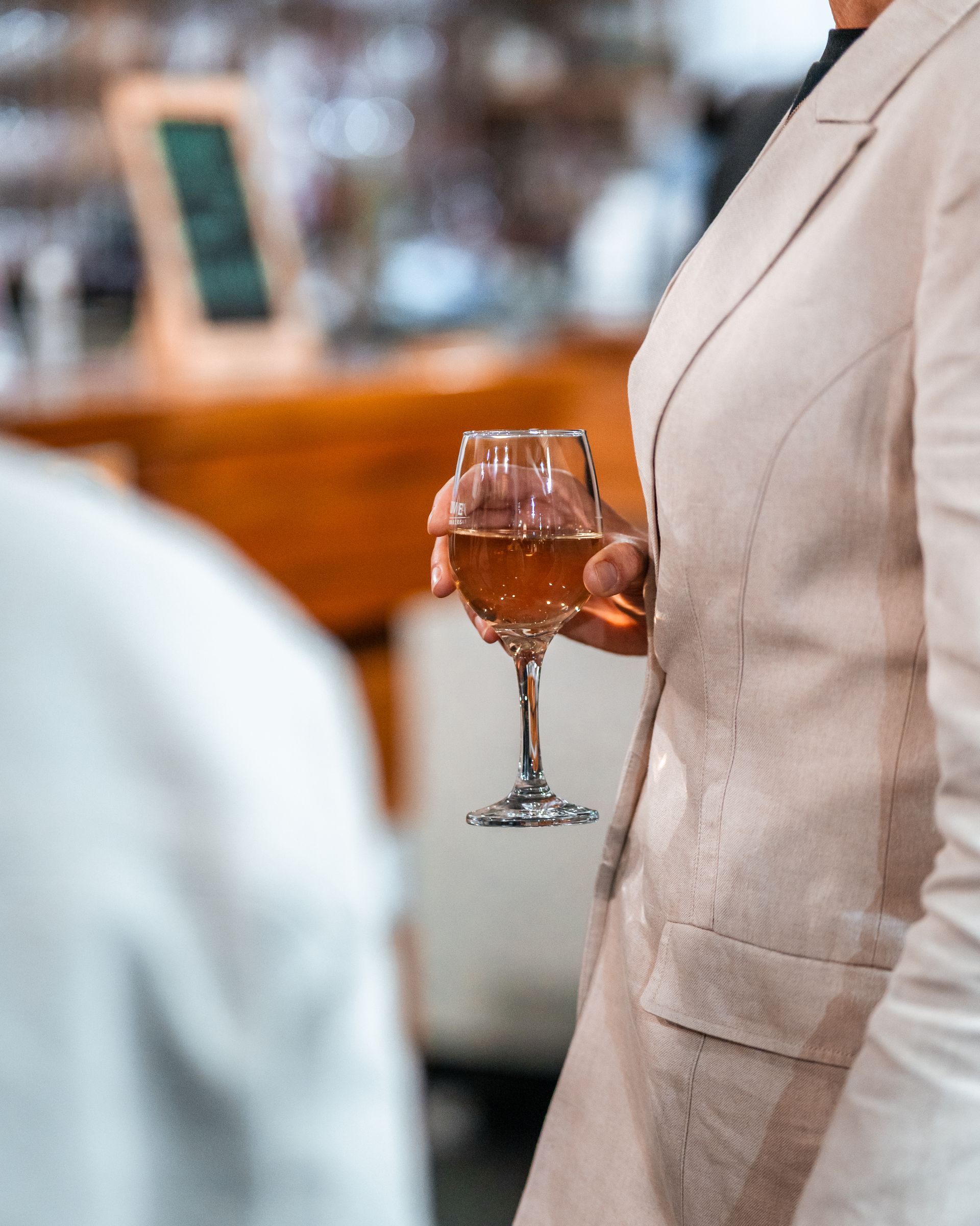 A Woman in A Suit Is Holding a Glass of Wine — Chop 'n Chill in Port Macquarie, NSW