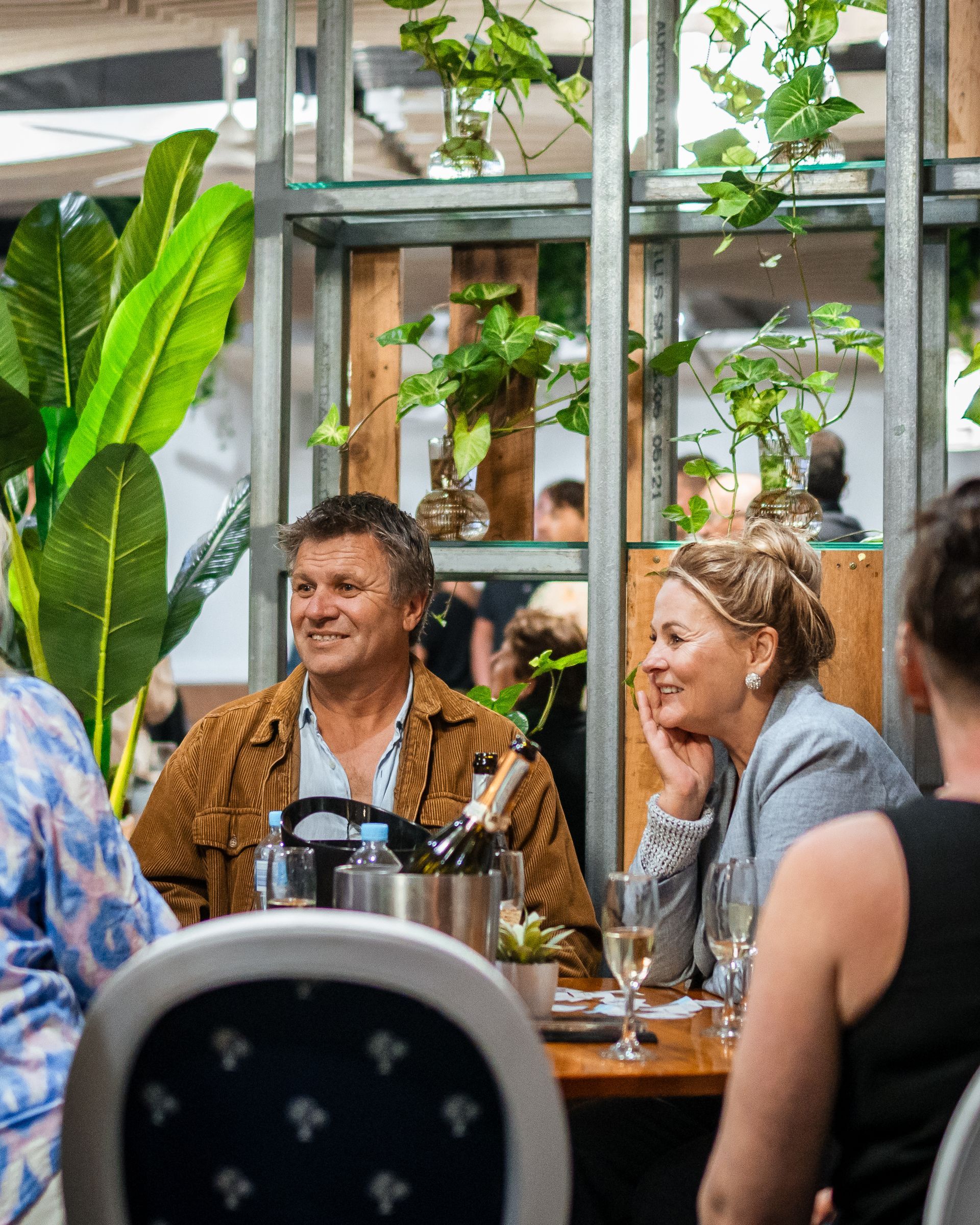 A Group of People Are Sitting at A Table in A Restaurant — Chop 'n Chill in Port Macquarie, NSW