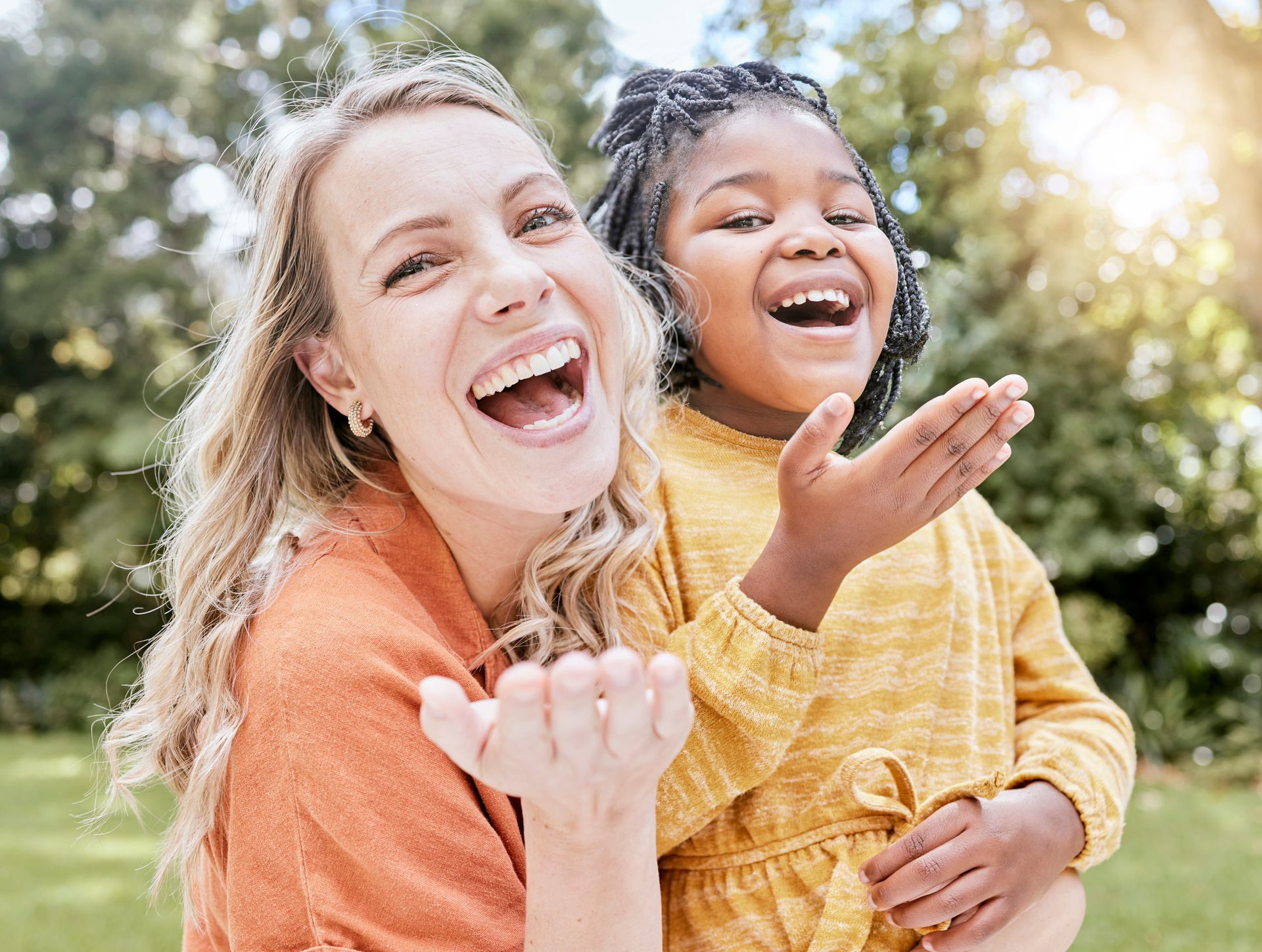 A woman is posing with a girl. A woman is posing with a girl.
