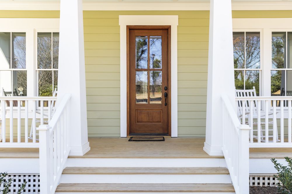 A Wooden Deck with White Wooden Railing On Porch — Bootle Timber QLD Pty Ltd in Garbutt, QLD