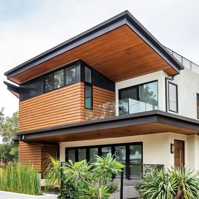 A Modern House with A Wooden Roof and A Balcony — Bootle Timber QLD Pty Ltd in Garbutt, QLD