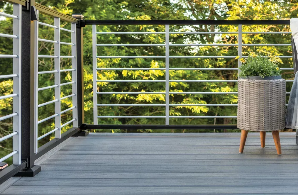 A Deck with A Wicker Chair and A Table on It — Bootle Timber QLD Pty Ltd in Rockhampton, QLD
