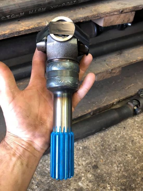 A person is holding a piece of metal in their hand.