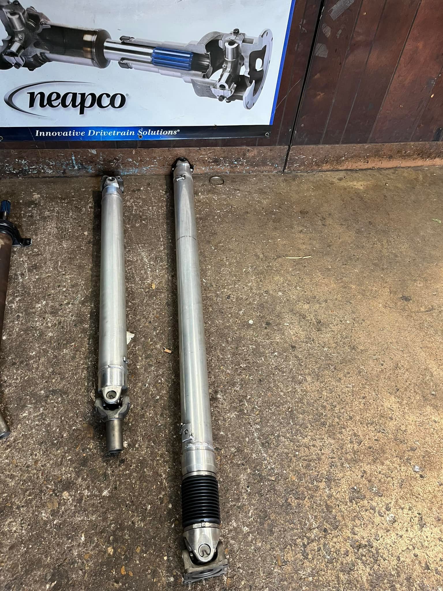 A pair of steering shafts are sitting on a table next to a box.