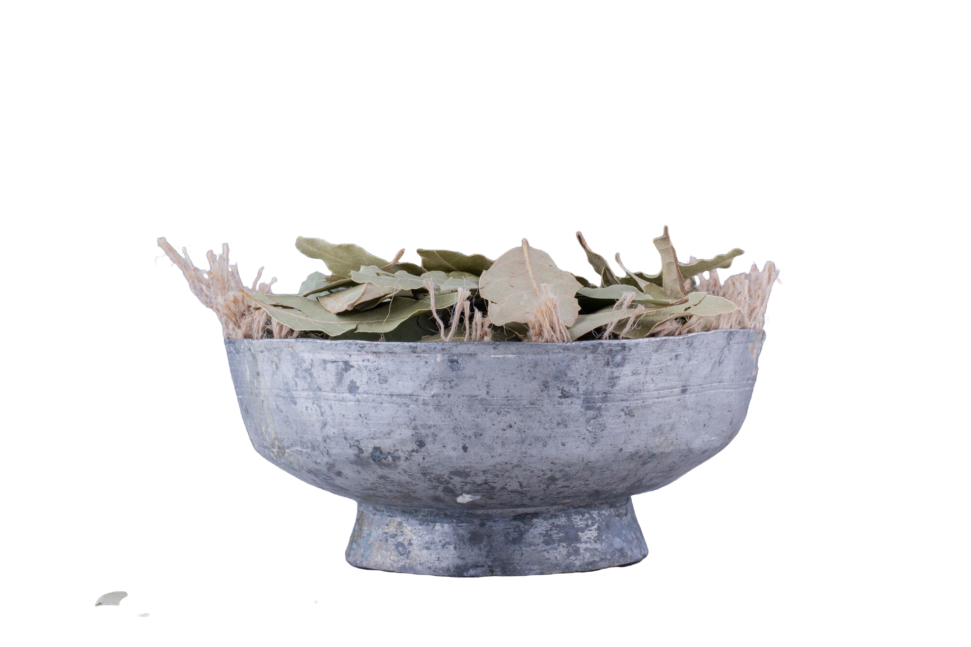 Gray metal bowl with dried leaves.