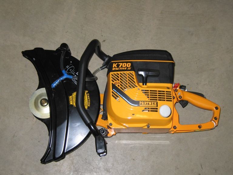 A mi-t-m corporation air compressor is sitting on the floor
