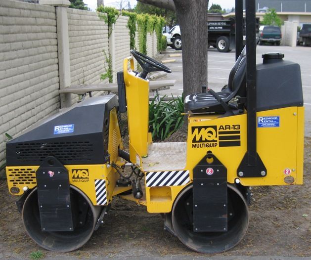 A bobcat t190 is parked in front of a fence.