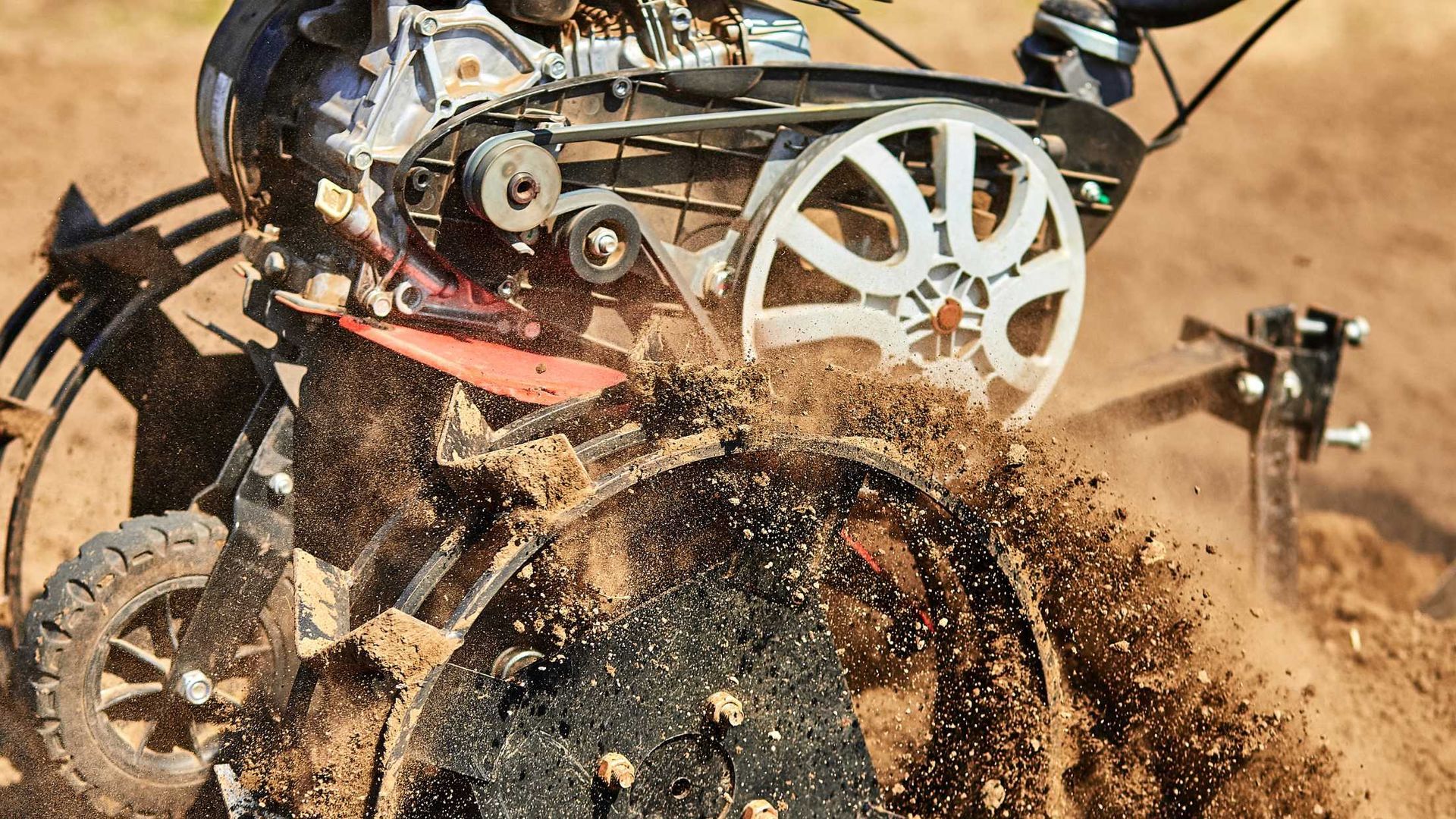 A person is riding a dirt bike on a dirt road.