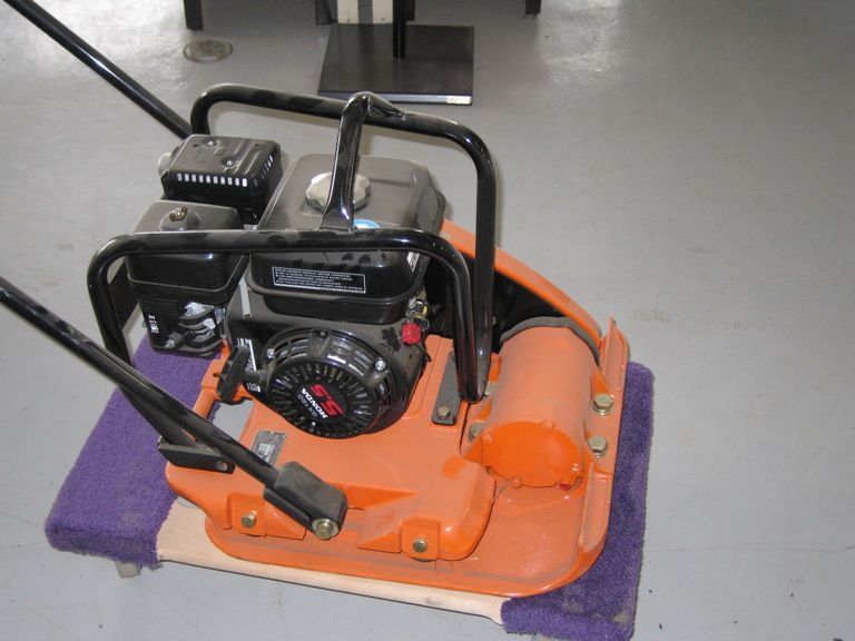 a green, white, and black colored box with an image and details about the Hitachi demolition hammer