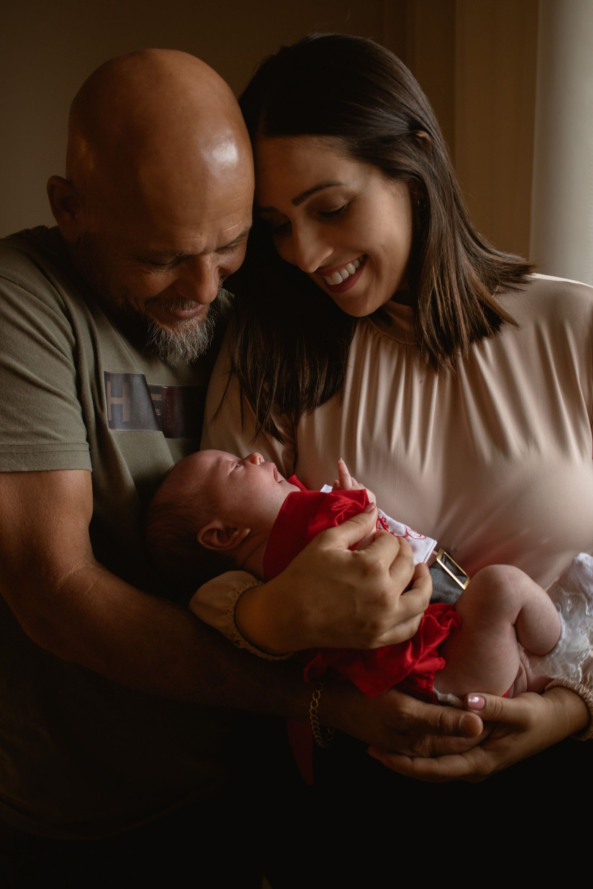 Couple cradling their newborn baby, highlighting the importance of estate planning for new parents in California