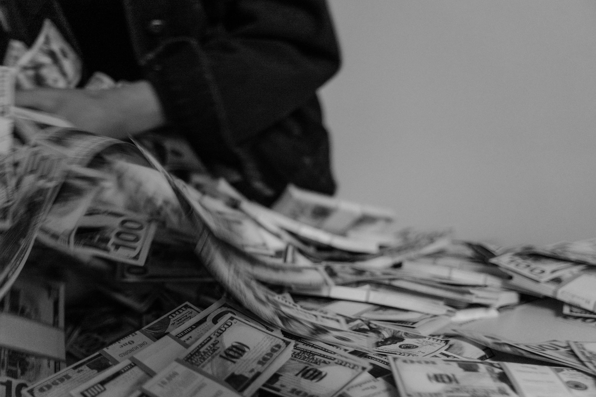 Large amount of cash on a table representing high-balance savings