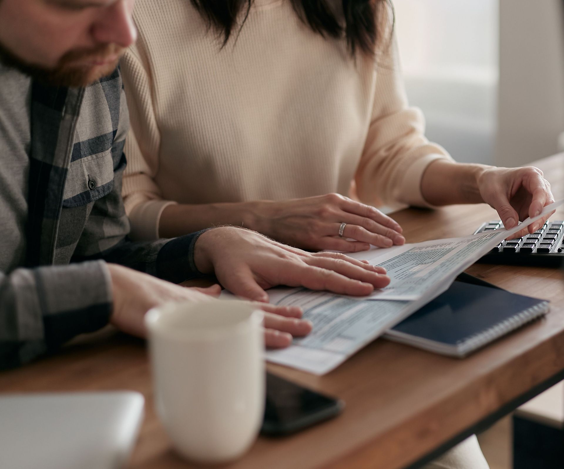 California couple reviewing living trust cost and estate planning documents with attorney.