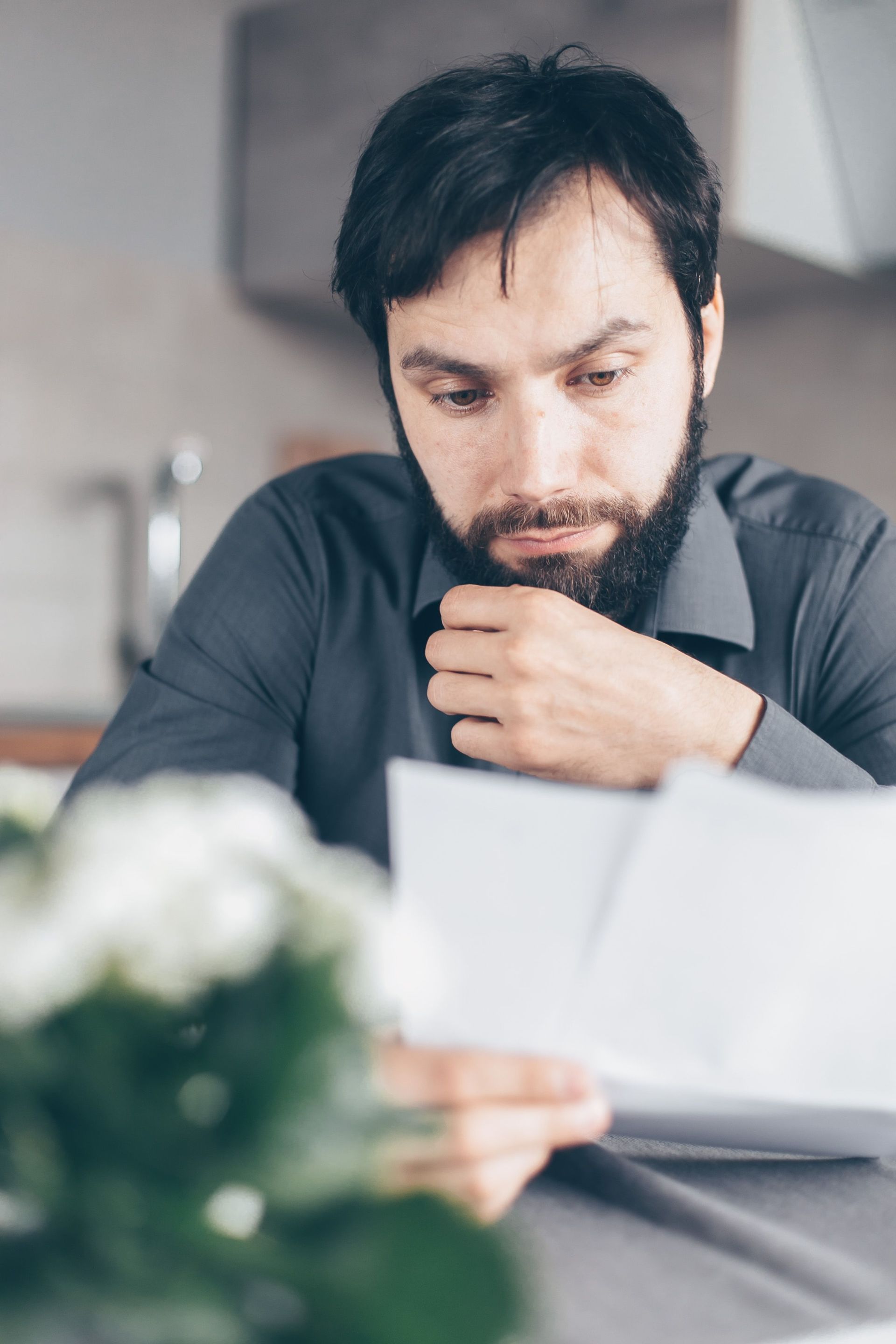 Person reviewing financial documents and calculator representing the cost of probate in California