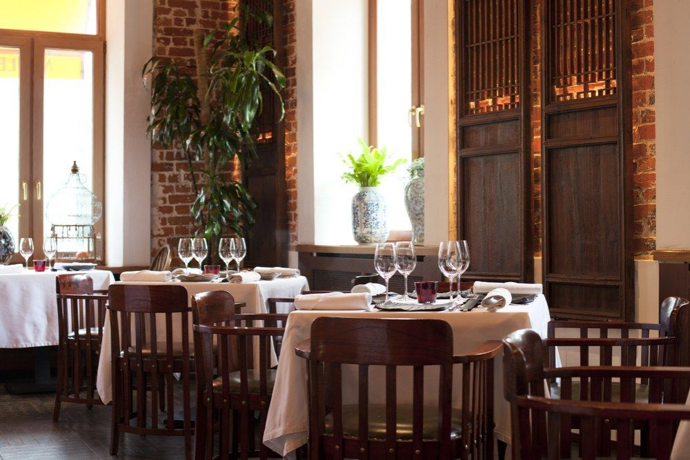 A Restaurant Filled With Tables and Chairs and Glasses of Wine — Kowin Restaurant in Wingham, NSW