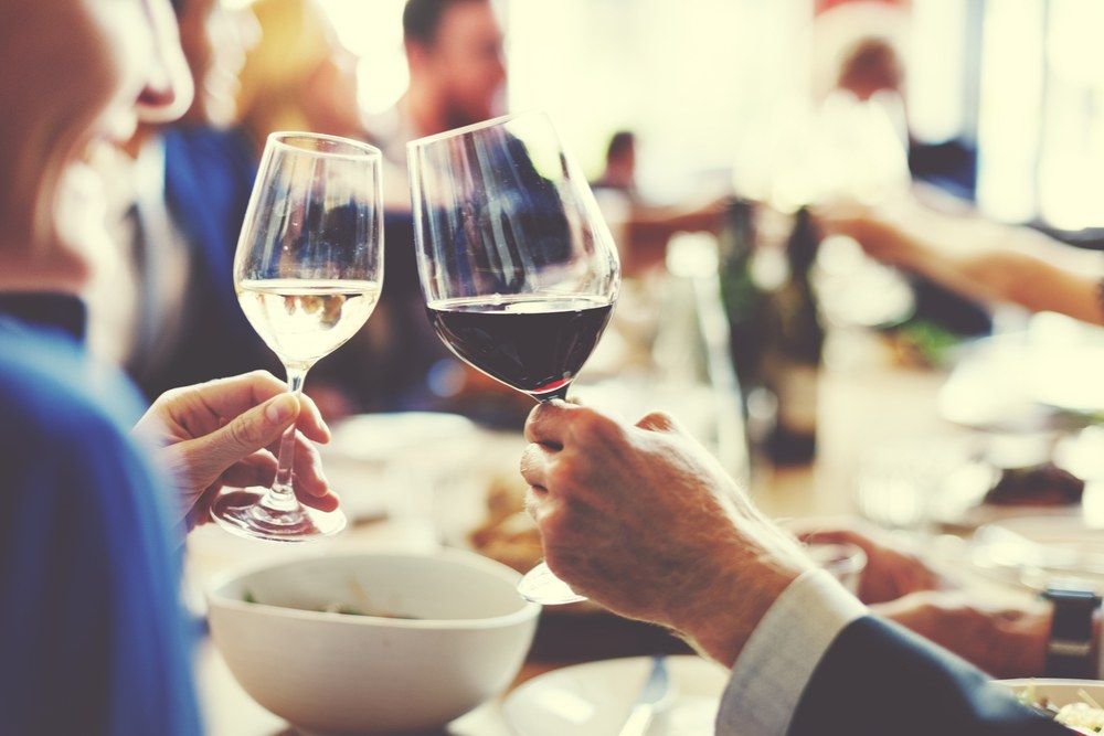 A Group of People Are Toasting With Wine Glasses at a Table — Kowin Restaurant in Old Bar, NSW