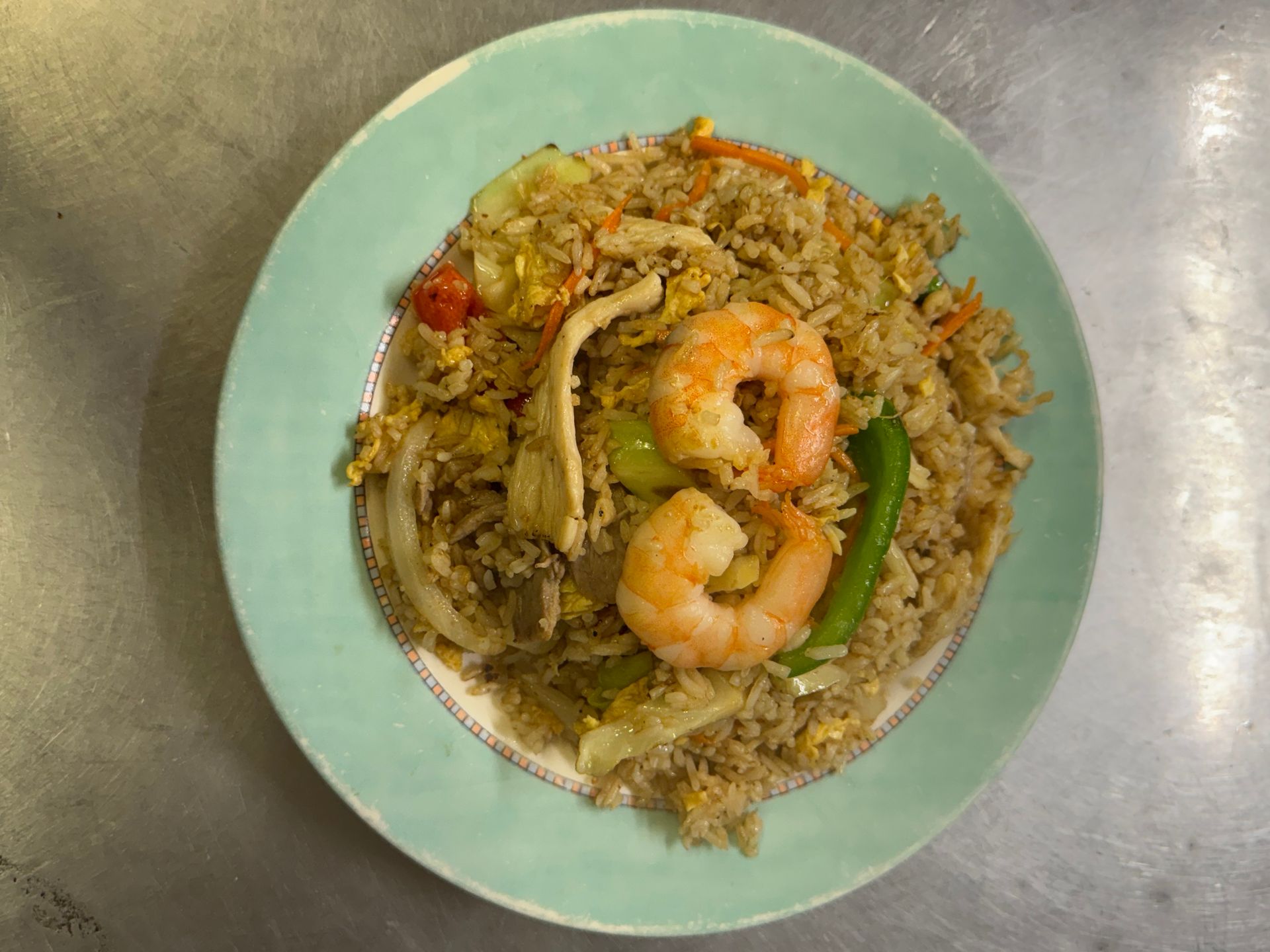 Fried rice with shrimp, chicken, and vegetables on a teal plate. — Kowin Restaurant in Taree, NSW