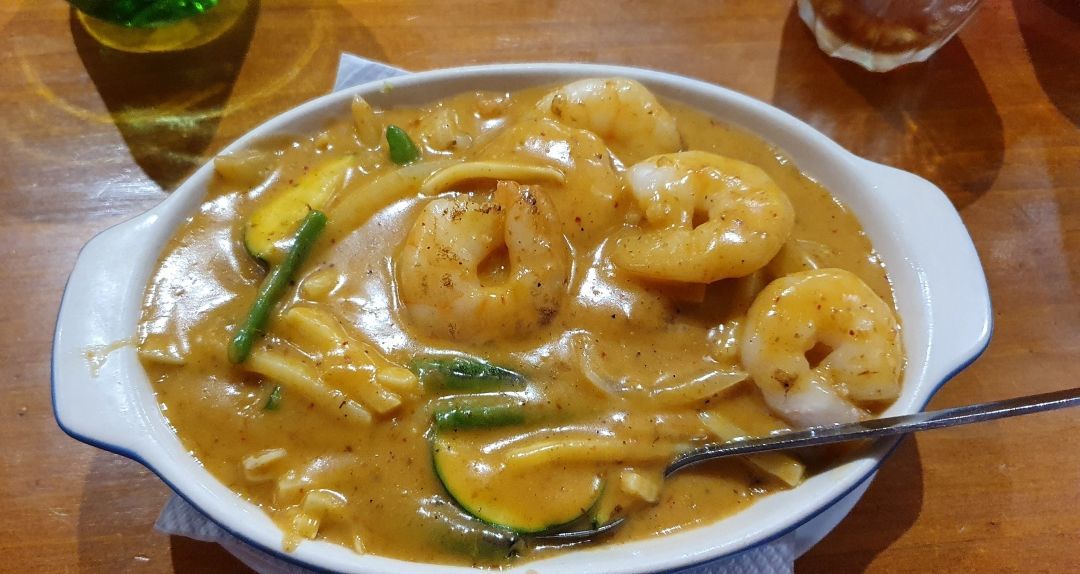 A Bowl of Shrimp and Vegetables With a Spoon in It on a Table — Kowin Restaurant in Taree, NSW