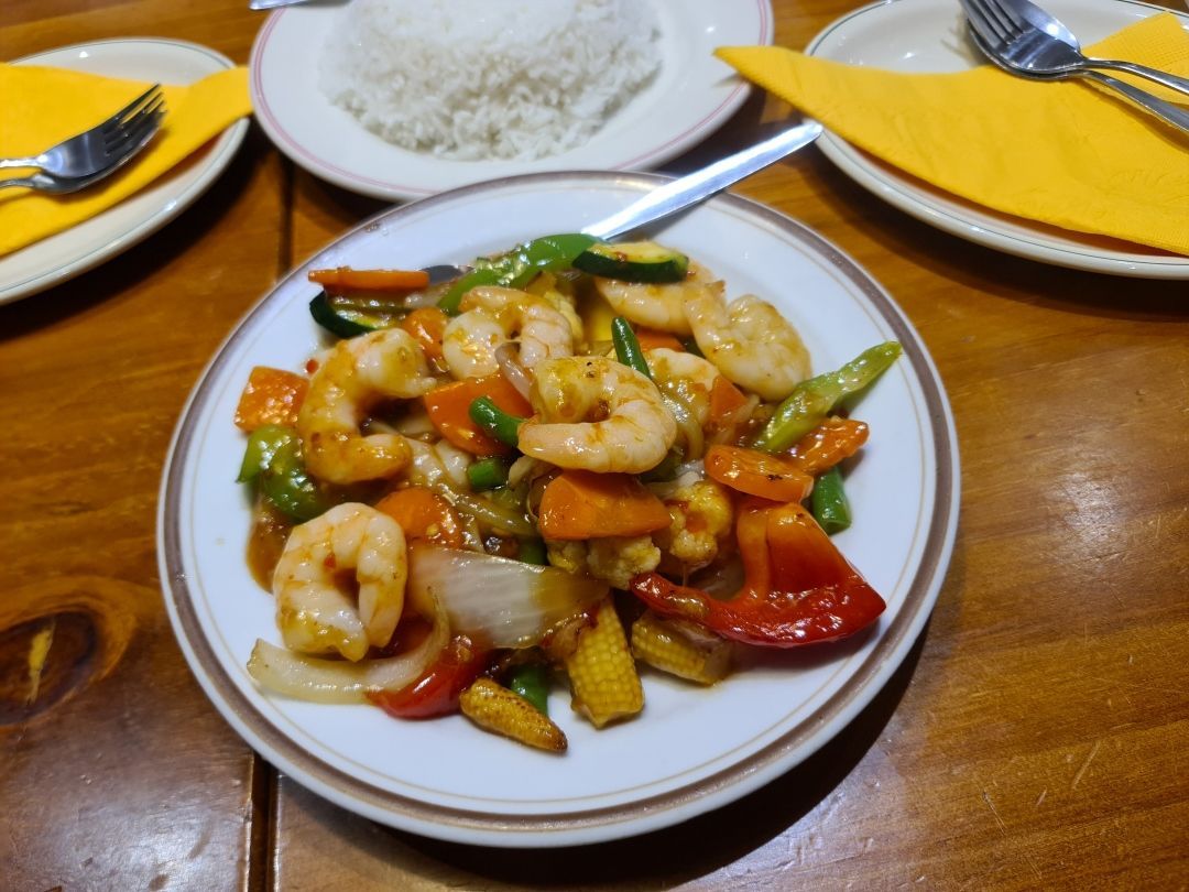 A plate of food with shrimp and vegetables on a table — Kowin Restaurant in Taree, NSW