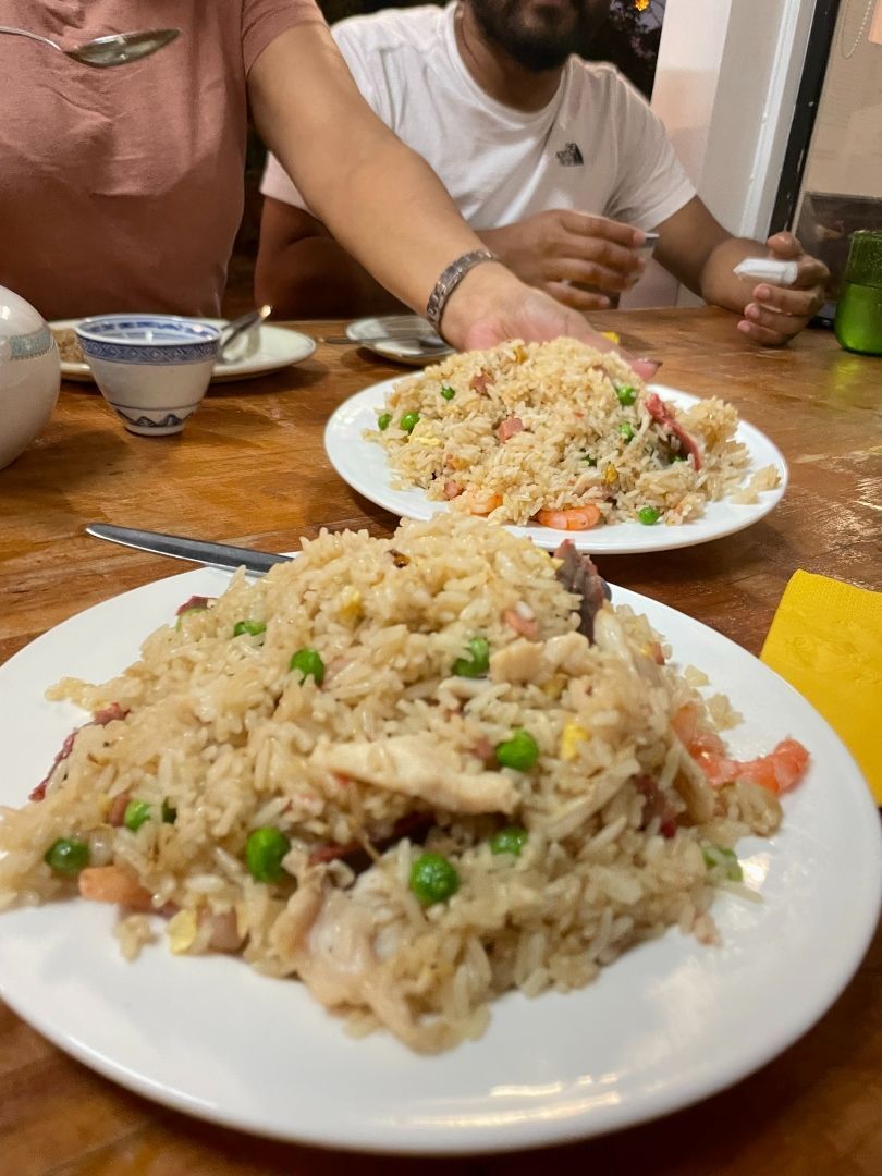 Two Plates of Fried Rice Are on a Wooden Table — Kowin Restaurant in Taree, NSW