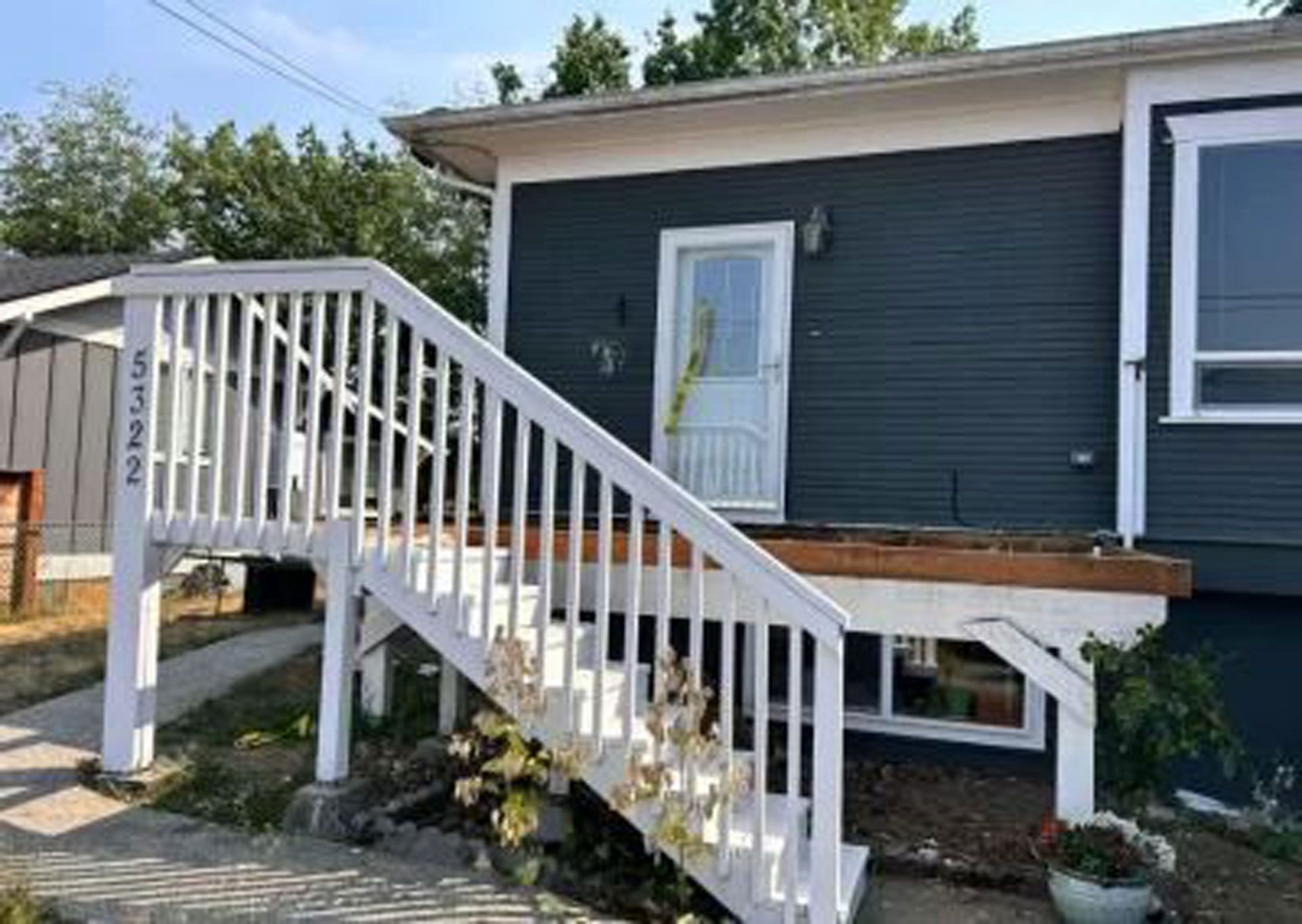 A house with a deck and stairs leading up to it