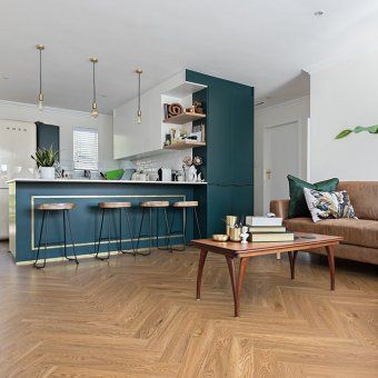 A living room with a couch , coffee table , and stools.