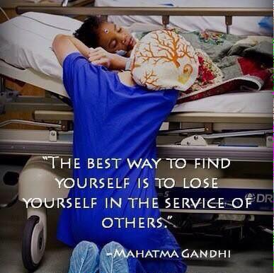 A medical worker kneels by a sleeping child in a hospital bed, quote by Gandhi.