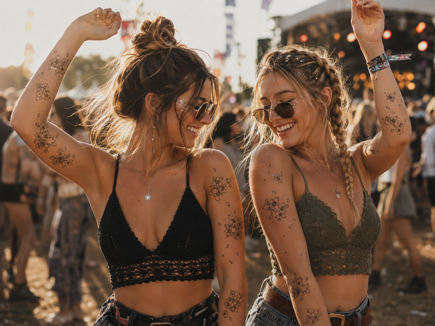 Two women dancing and smiling at an outdoor party in warm sunset light