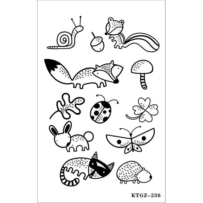 Hands with botanical and symbol tattoos over a notebook at a desk