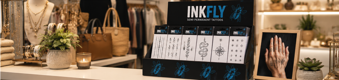 INKFLY ad with wings graphic and text: “Real look, temporary attitude, no needles” on teal and black background