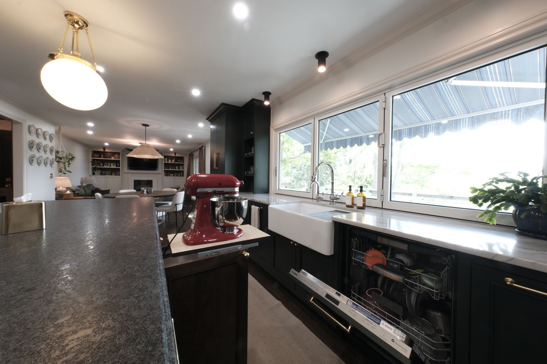 A kitchen with white cabinets and a wooden bench in the middle.