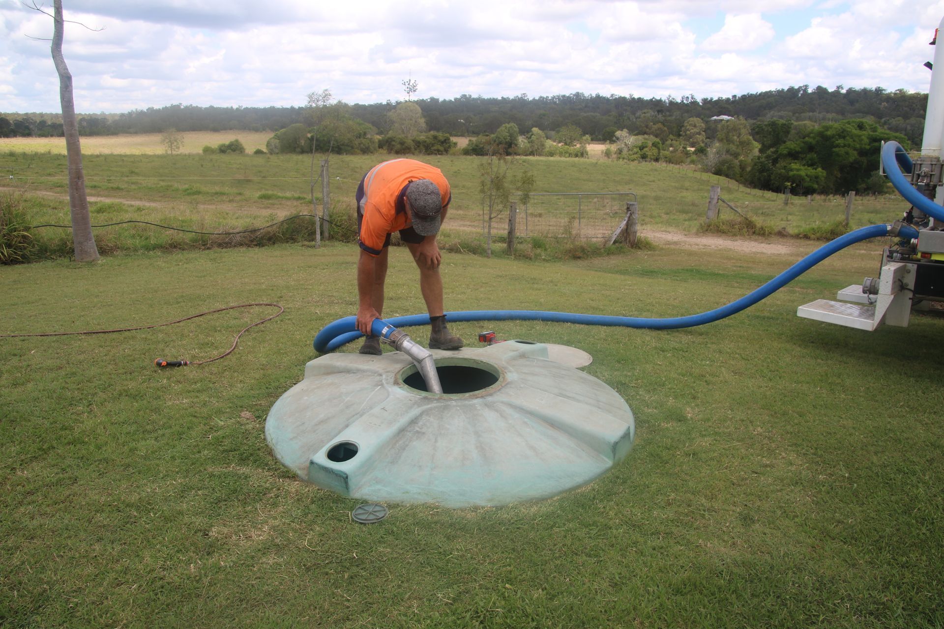 A blue tray is sitting in the middle of a hole in the ground.