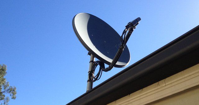 Worker Installing Satellite Dish — Antenna Installation In Clarence Valley NSW
