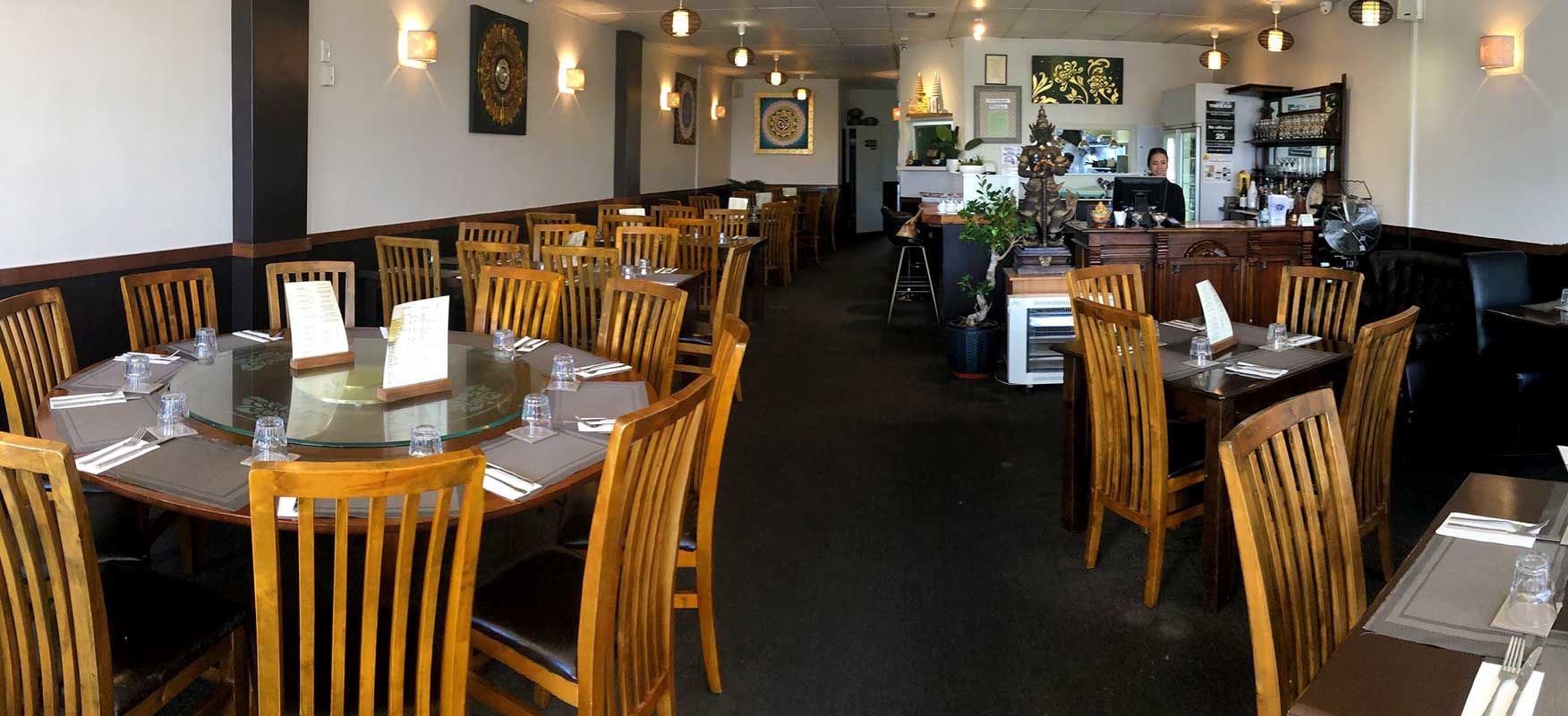 There are many tables and chairs in the restaurant.