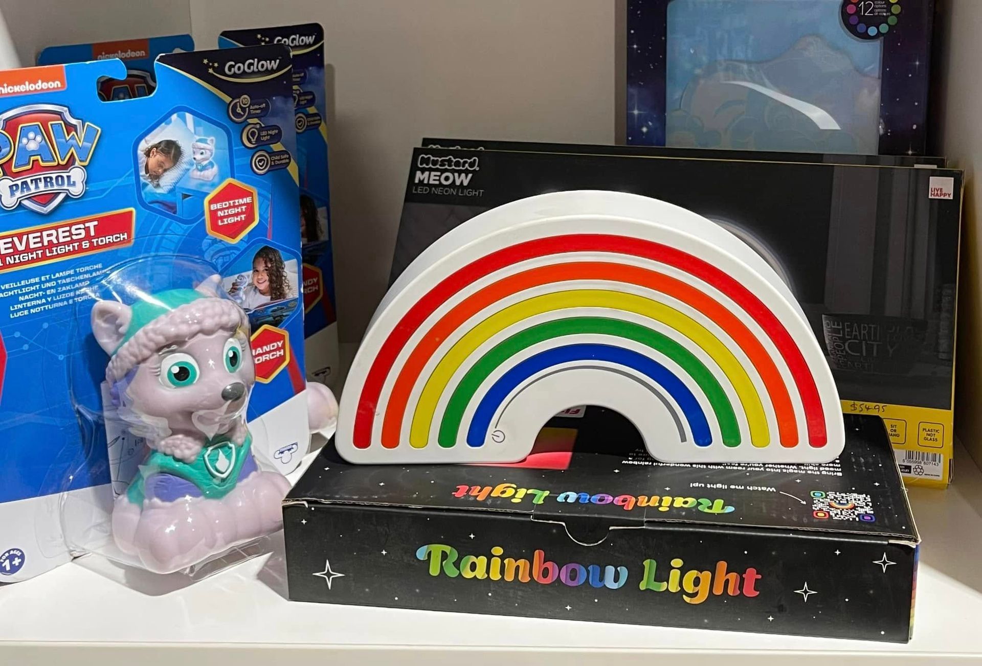 A Rainbow-shaped Night Light Sits on a Shelf With Other Toys — Enterprise Electrics NT Pty Ltd in Tennant Creek, NT