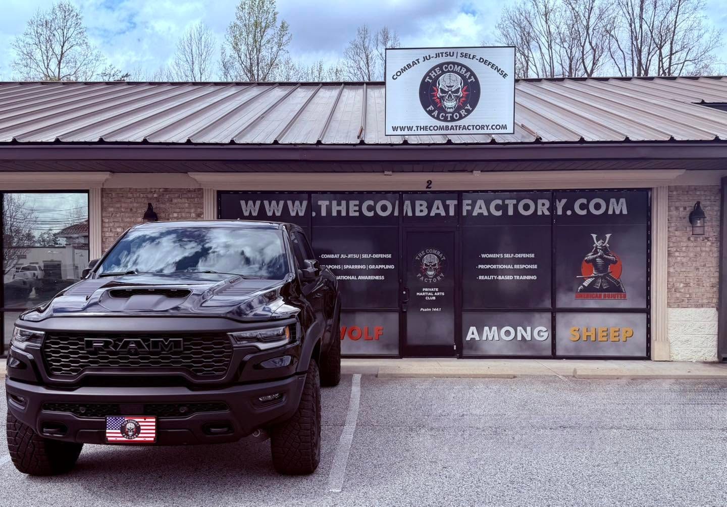 Black SUV parked in front of The Cobalt Factory storefront with signage and wide windows