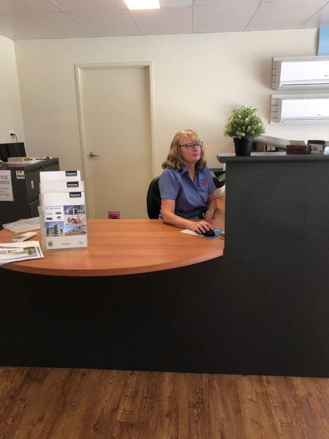 A Woman is Browsing Through Her Computer - Refrigeration Service in South Burnett, QLD