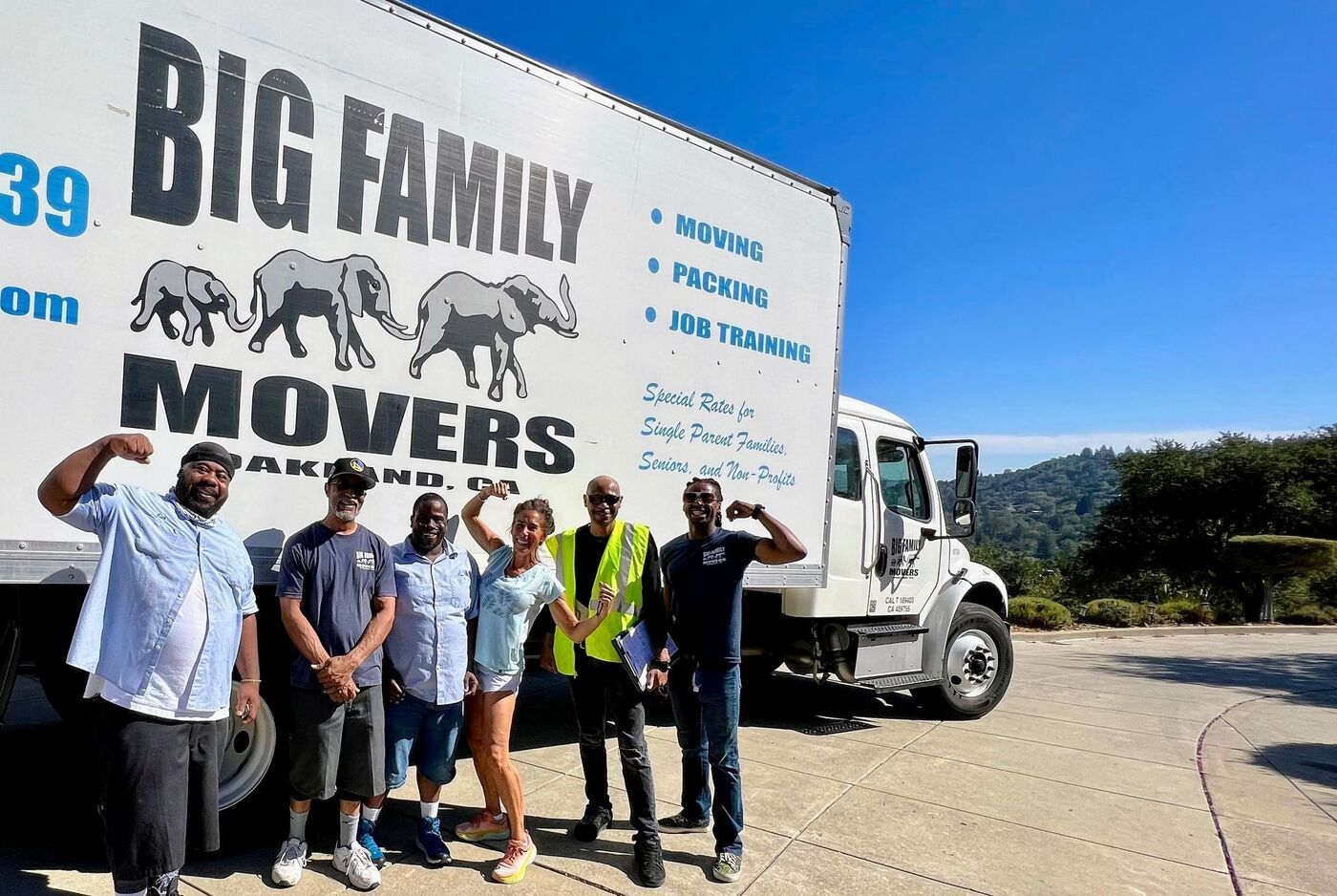 The Big Family Movers crew standing with their moving truck in Oakland