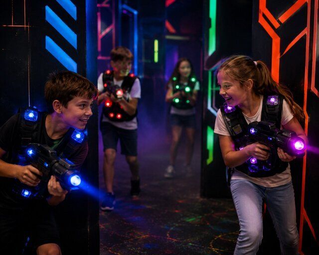 happy children using laser tag guns