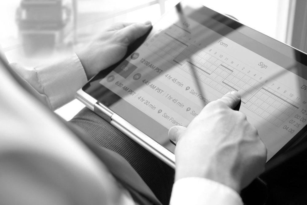 A Black And White Photo Of A Person Using A Tablet — Advanced Auto Tech In Port Macquarie, NSW
