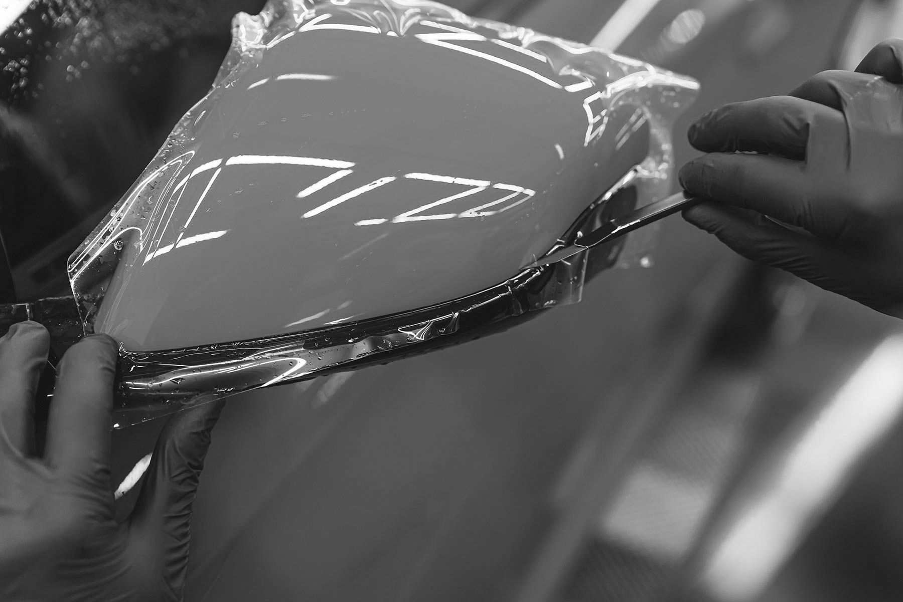 A Person Is Wrapping A Car With Vinyl Wrap — Advanced Auto Tech In Port Macquarie, NSW