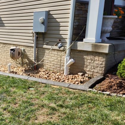 Installing gutter drains to move water away from foundation
