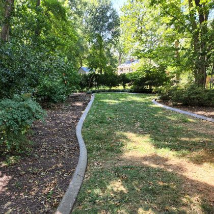 Installing concrete edging curbing between lawn and landscaping