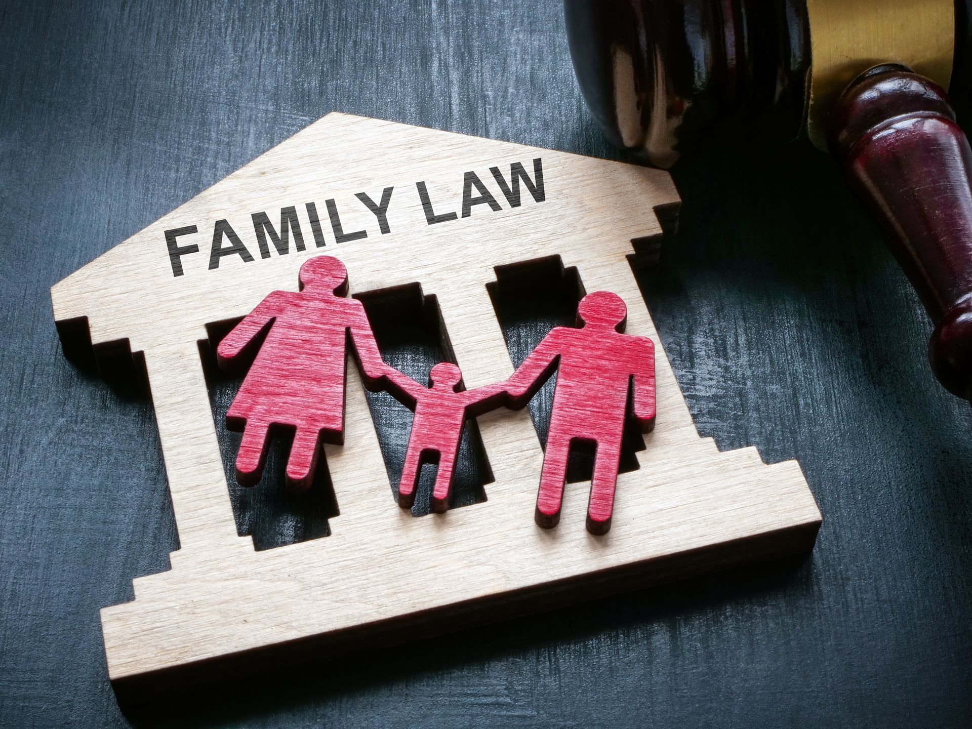 A wooden model of a family law building with a gavel.