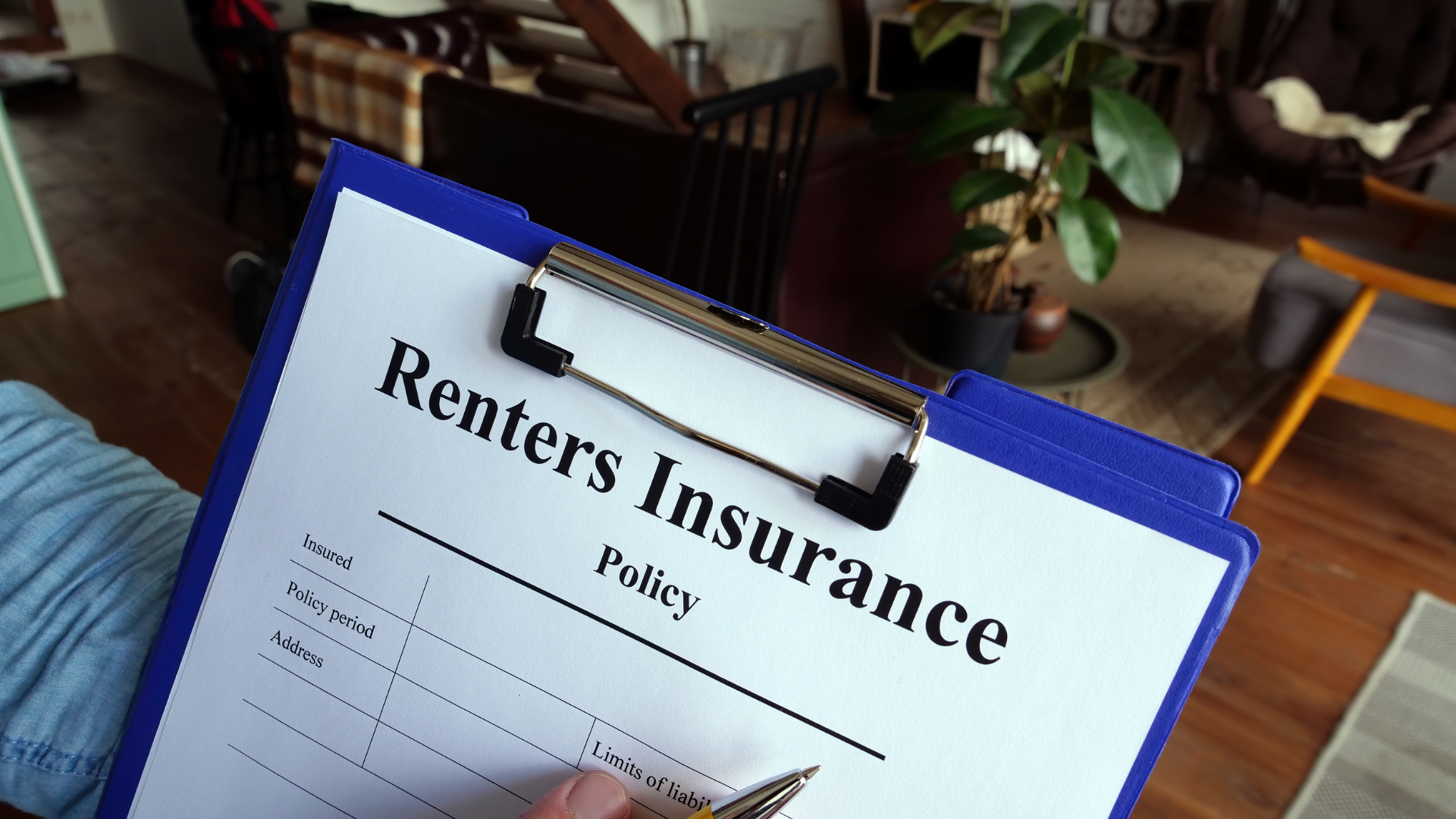 Clipboard with “Renters Insurance” policy form on a desk in an office setting