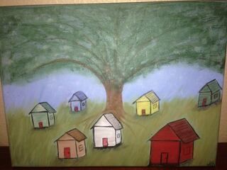 Crayon drawing of a large tree over small colorful houses on a grassy hill.